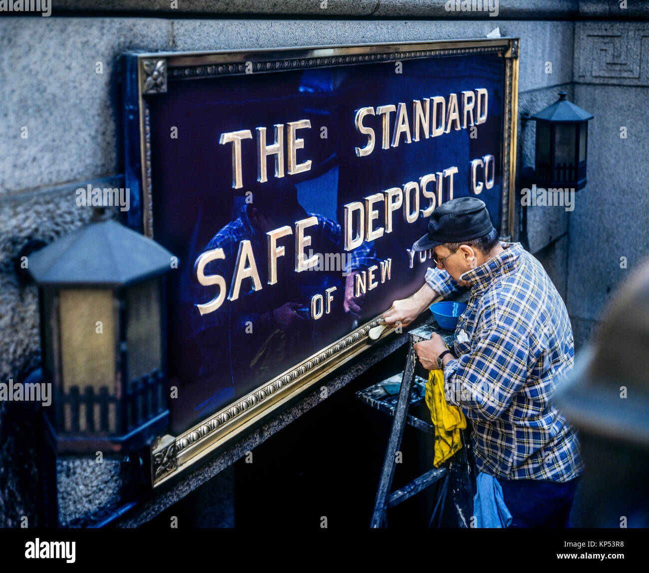 May 1982,New York,worker polishing brass sign,The Standard Safe Deposit Co of New York,Manhattan,New york City,NY,NYC,USA, Stock Photo