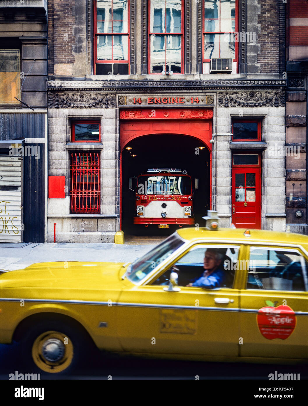 May 1982,New York,moving yellow cab,fire station house Engine 14,NYFD,14 East 18th street,Manhattan,New york City,NY,NYC,USA, Stock Photo