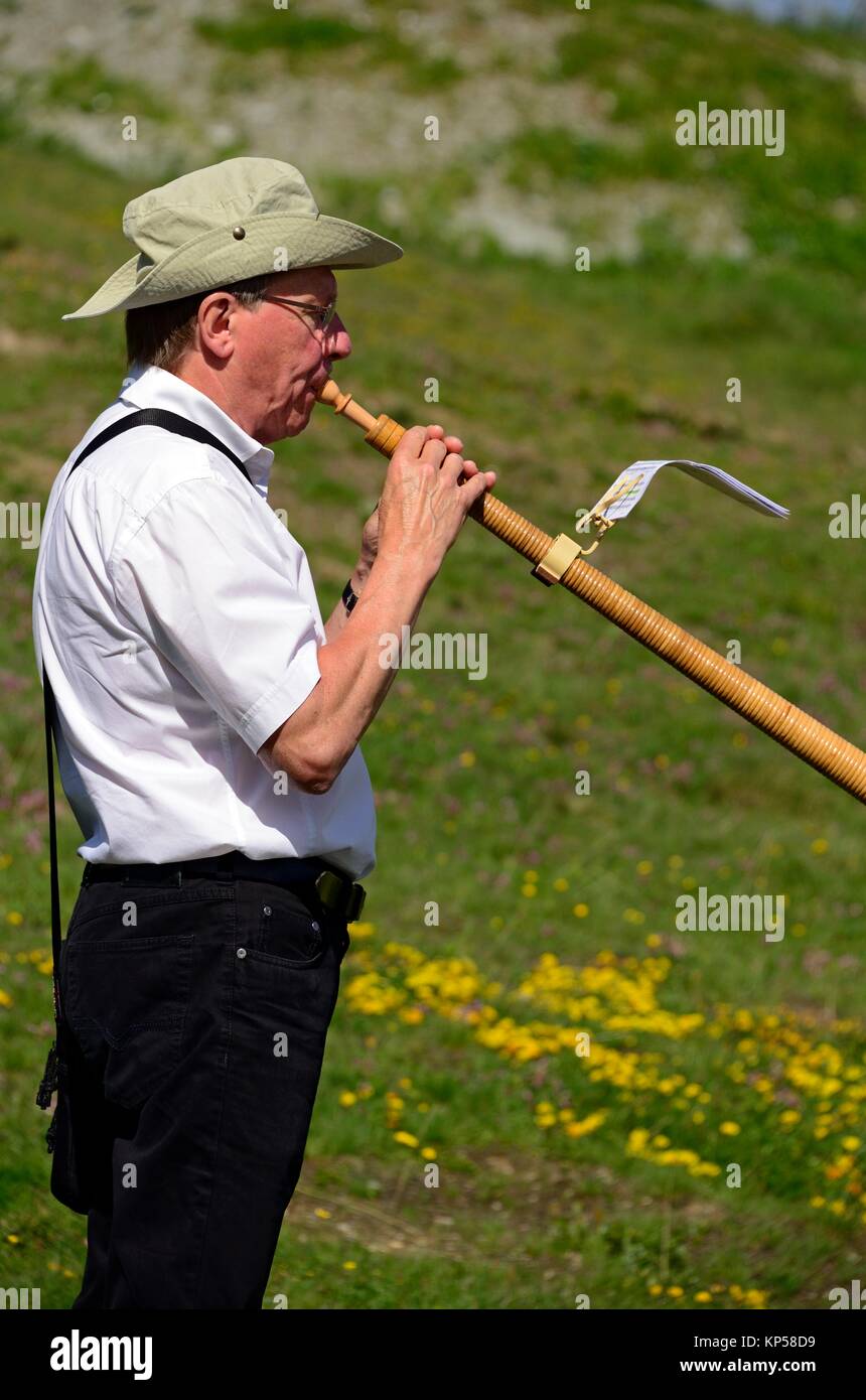 single man playing alphorn, Nendaz, canton Valais, canton Wallis, Switzerland. Stock Photo