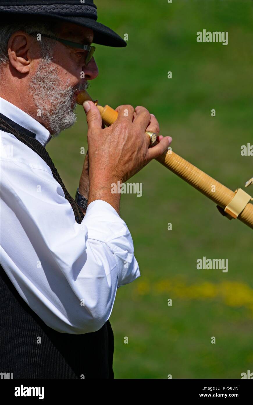 single man playing alphorn, Nendaz, canton Valais, canton Wallis, Switzerland. Stock Photo