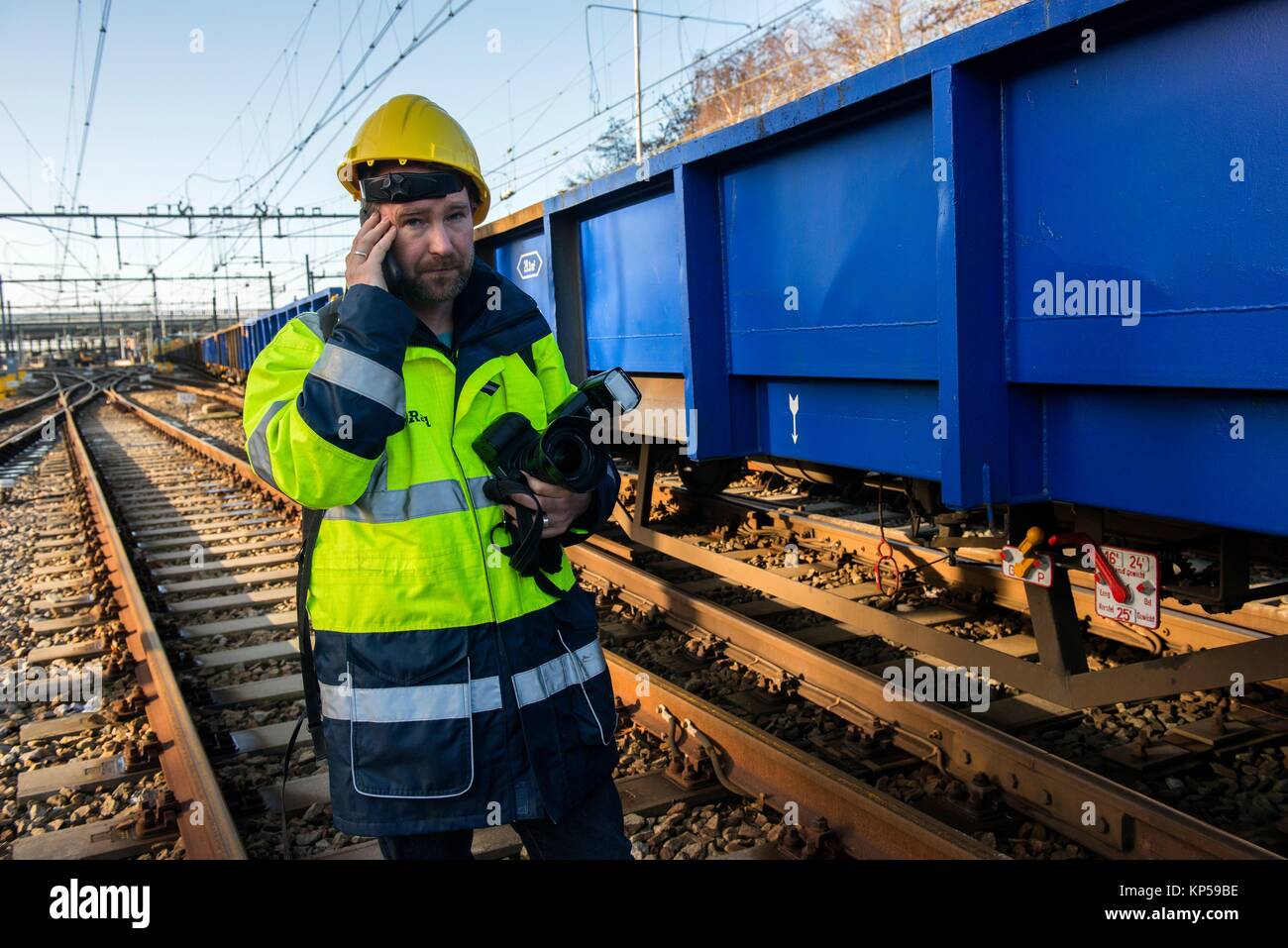 Rotterdam, Netherlands. Male spokesman of ProRail railway infrastructure corporation checking up on major overhaul of a railroad track inside the Stock Photo