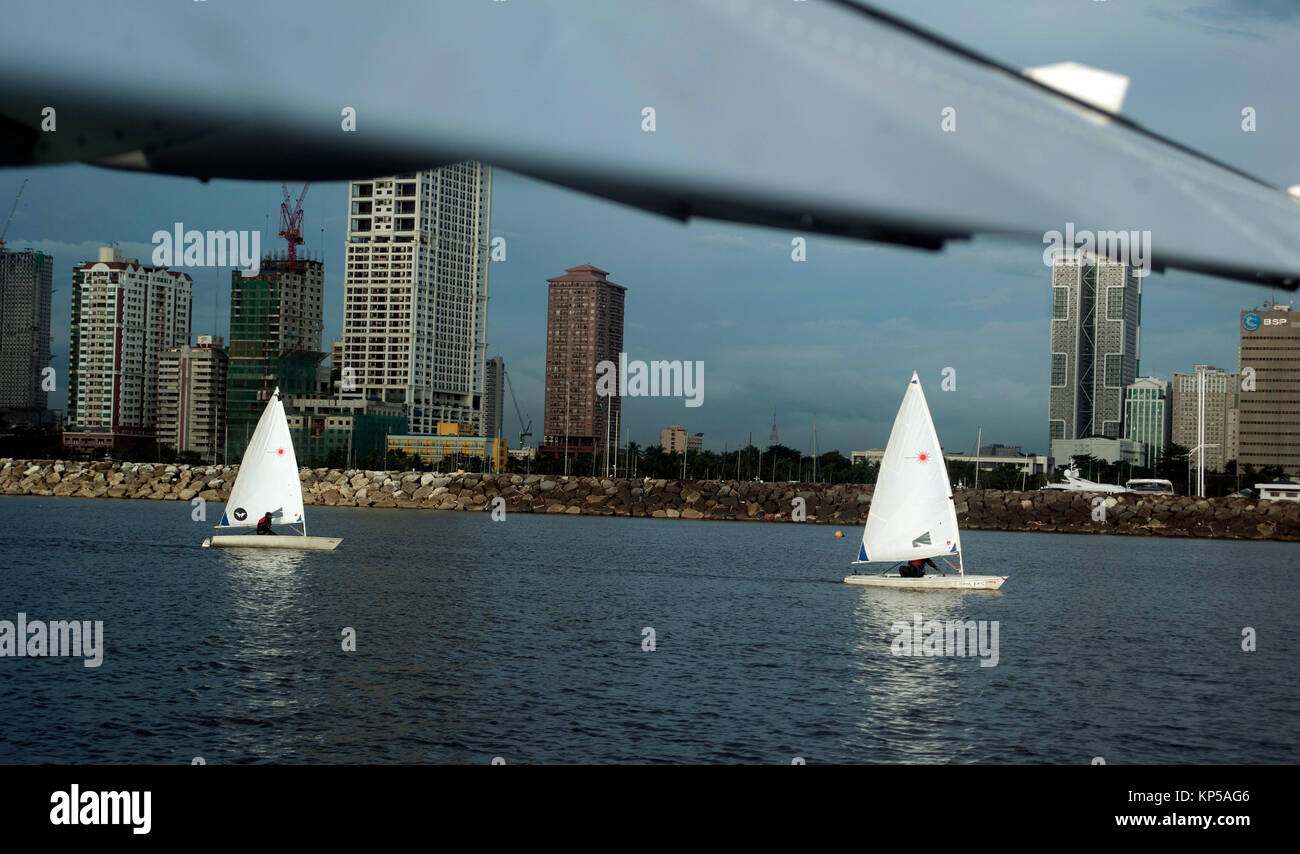 Sail boats in Manila Bay, from under the wing of a sea plane, Metro Manila, Philippines, South East Asia Stock Photo