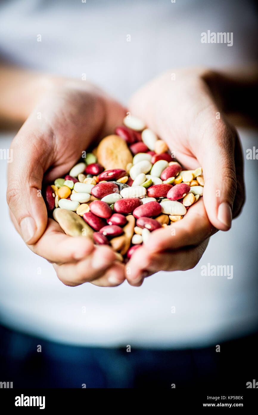 Woman holding an assorted beans and pulse. Stock Photo