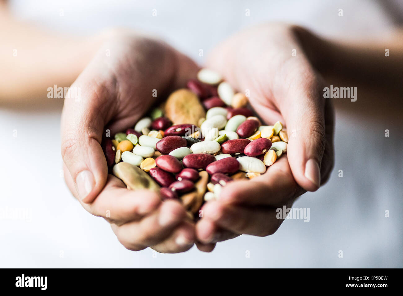 Woman holding an assorted beans and pulse. Stock Photo