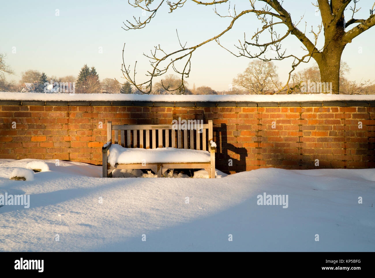 Empty bench in the snow Stock Photo - Alamy