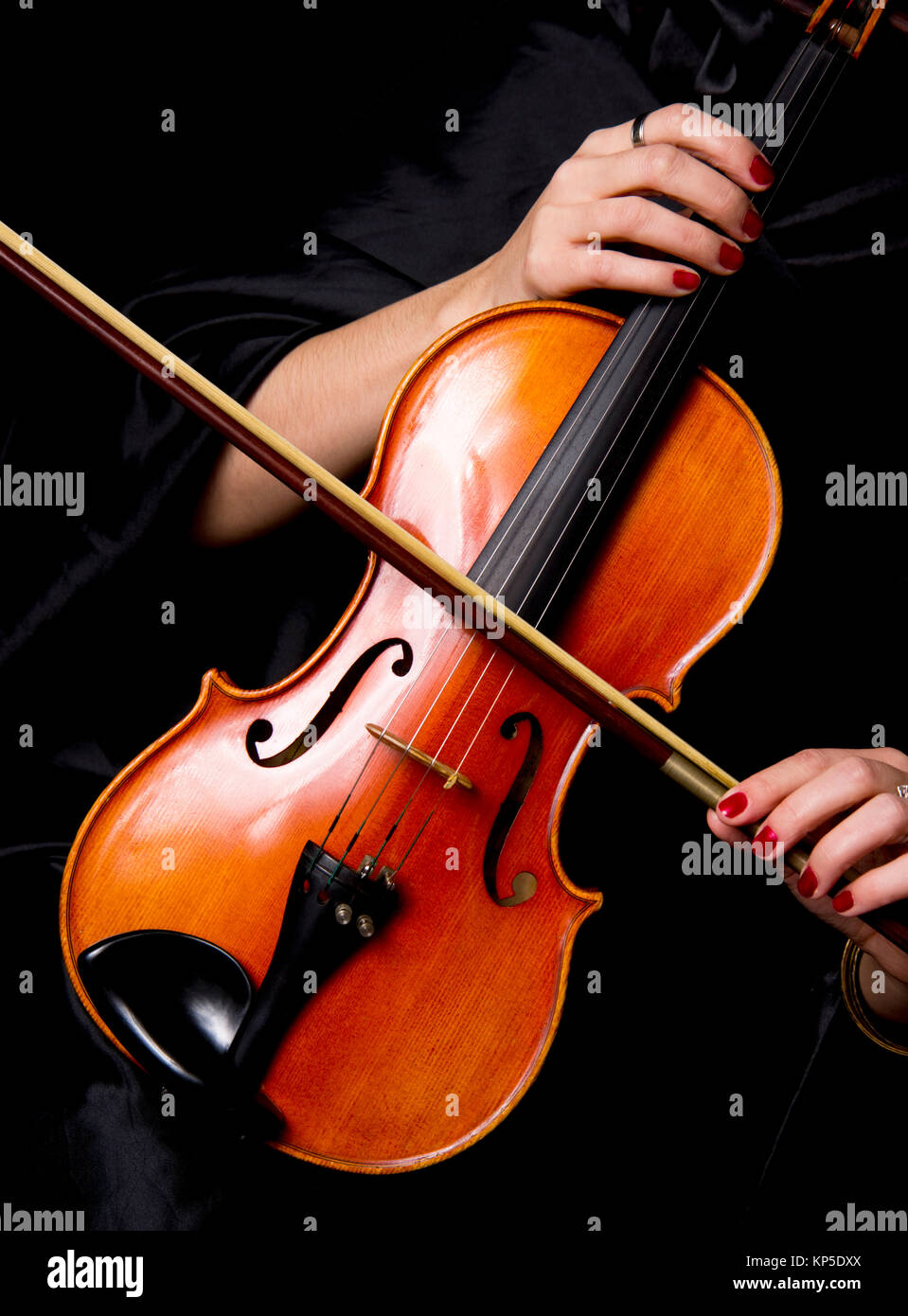 Violinist Holds Bow Across Saturated Musical Violin Stock Photo