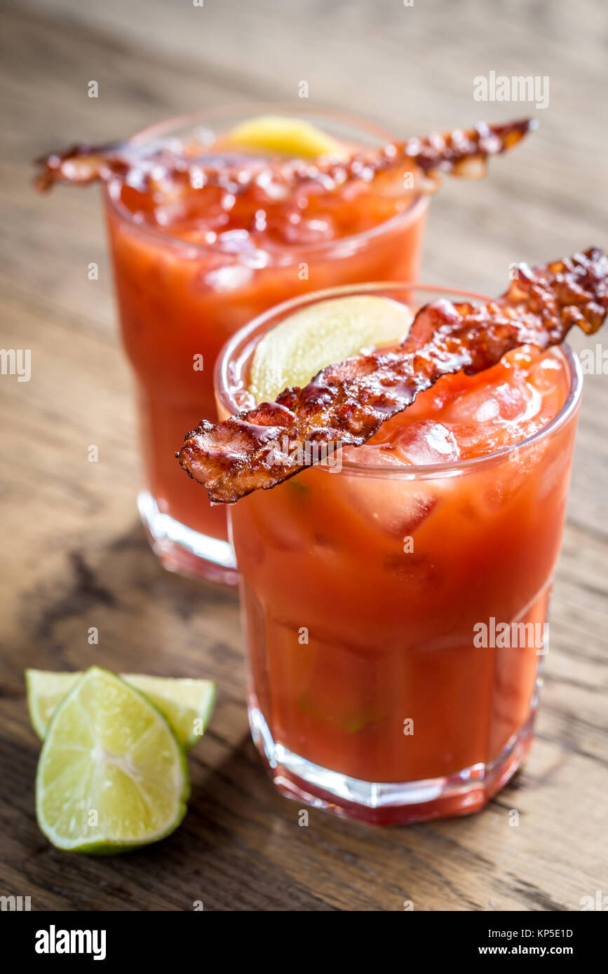 Two glasses of Bloody Mary with bacon rashers Stock Photo