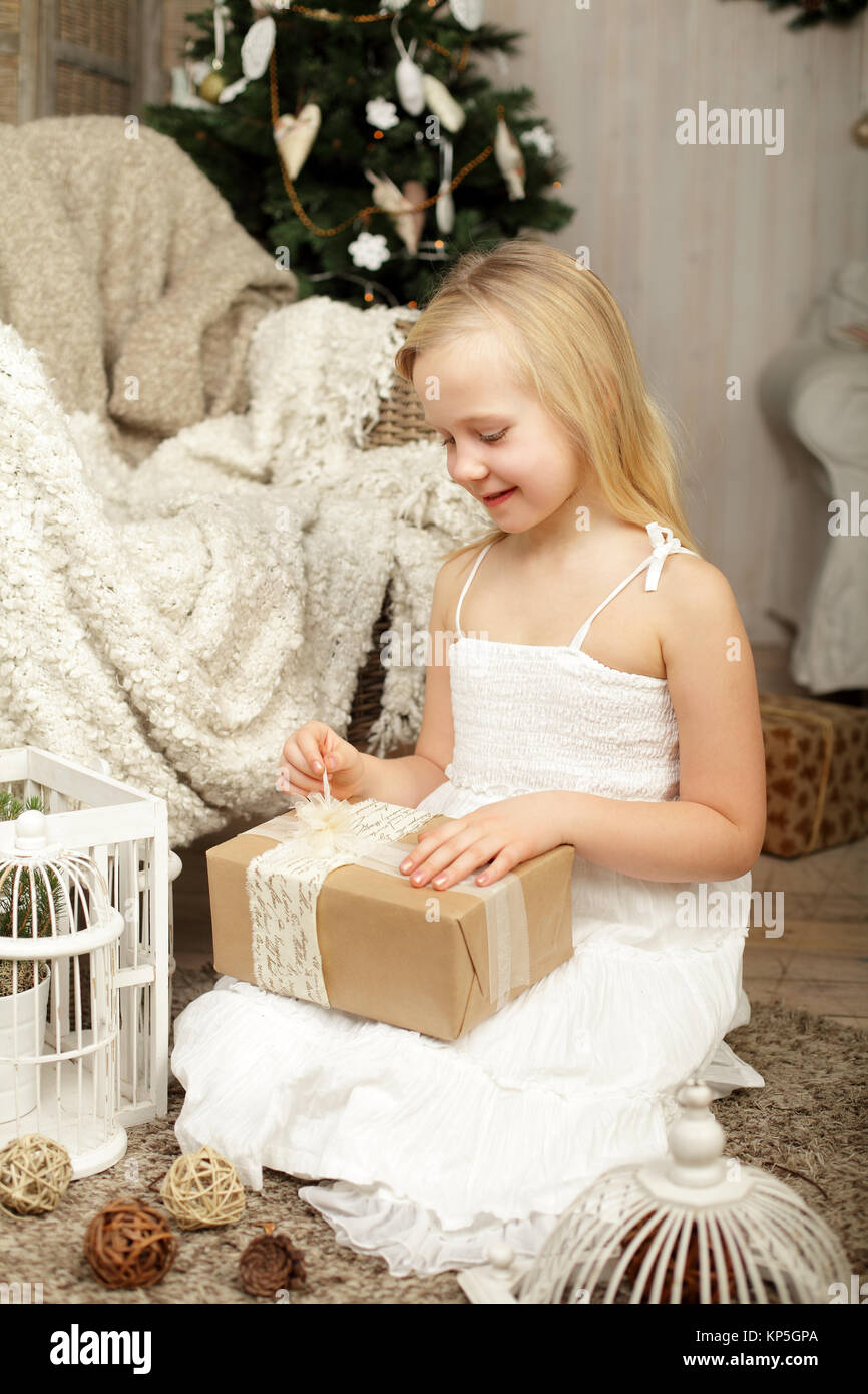 Child with Christmas gift at home Stock Photo - Alamy