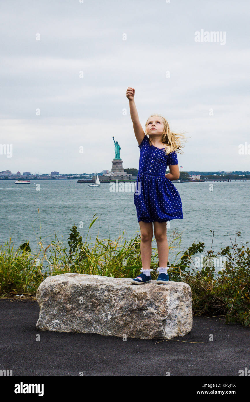 a girl standing tall and strong like statue of liberty to represent