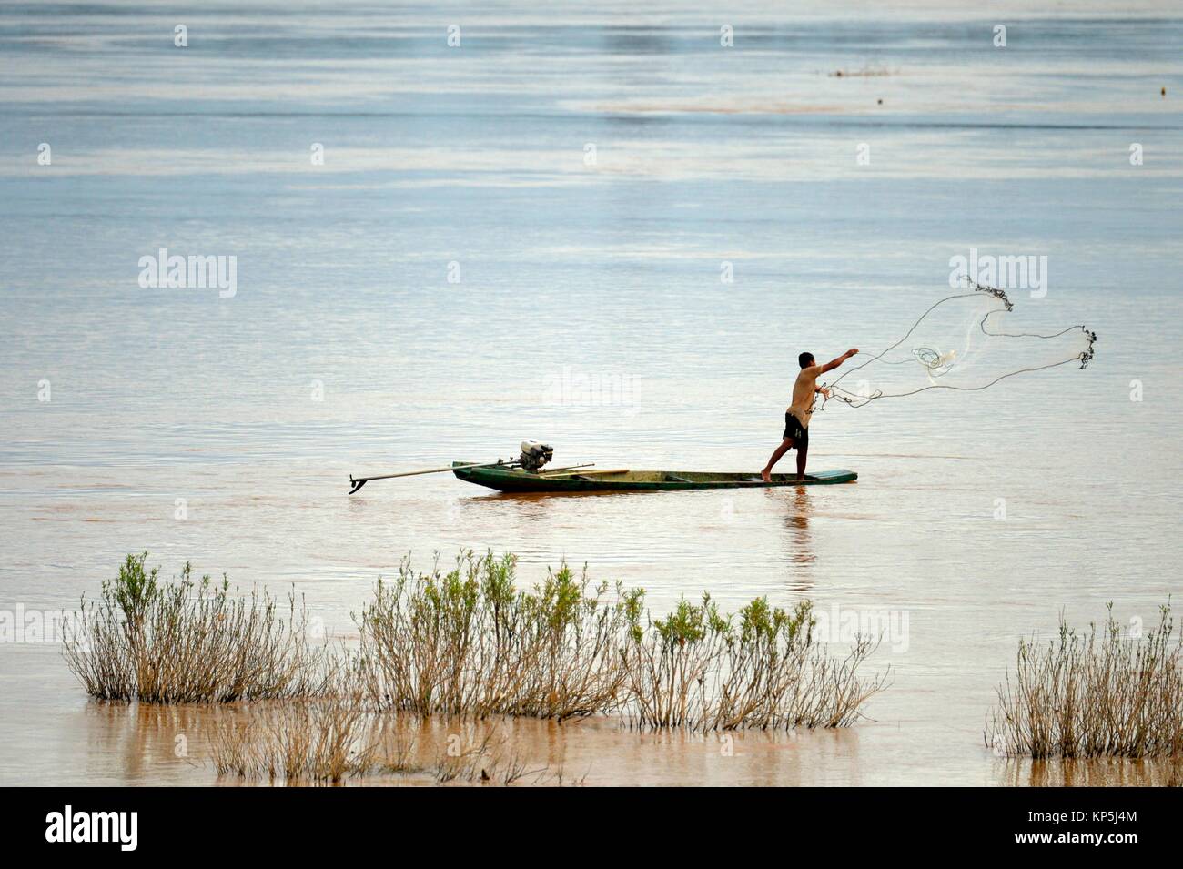A fisherman fishing with a net,Four Thousand islands, South Laos,Southeast Asia. Stock Photo