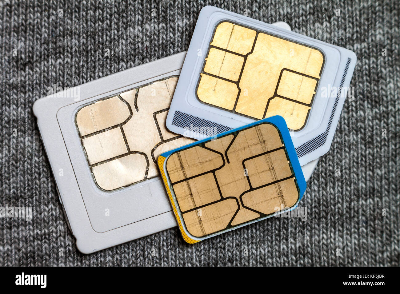 Set of mini, micro and nano simcard. Isolated on grey cloth texture ...