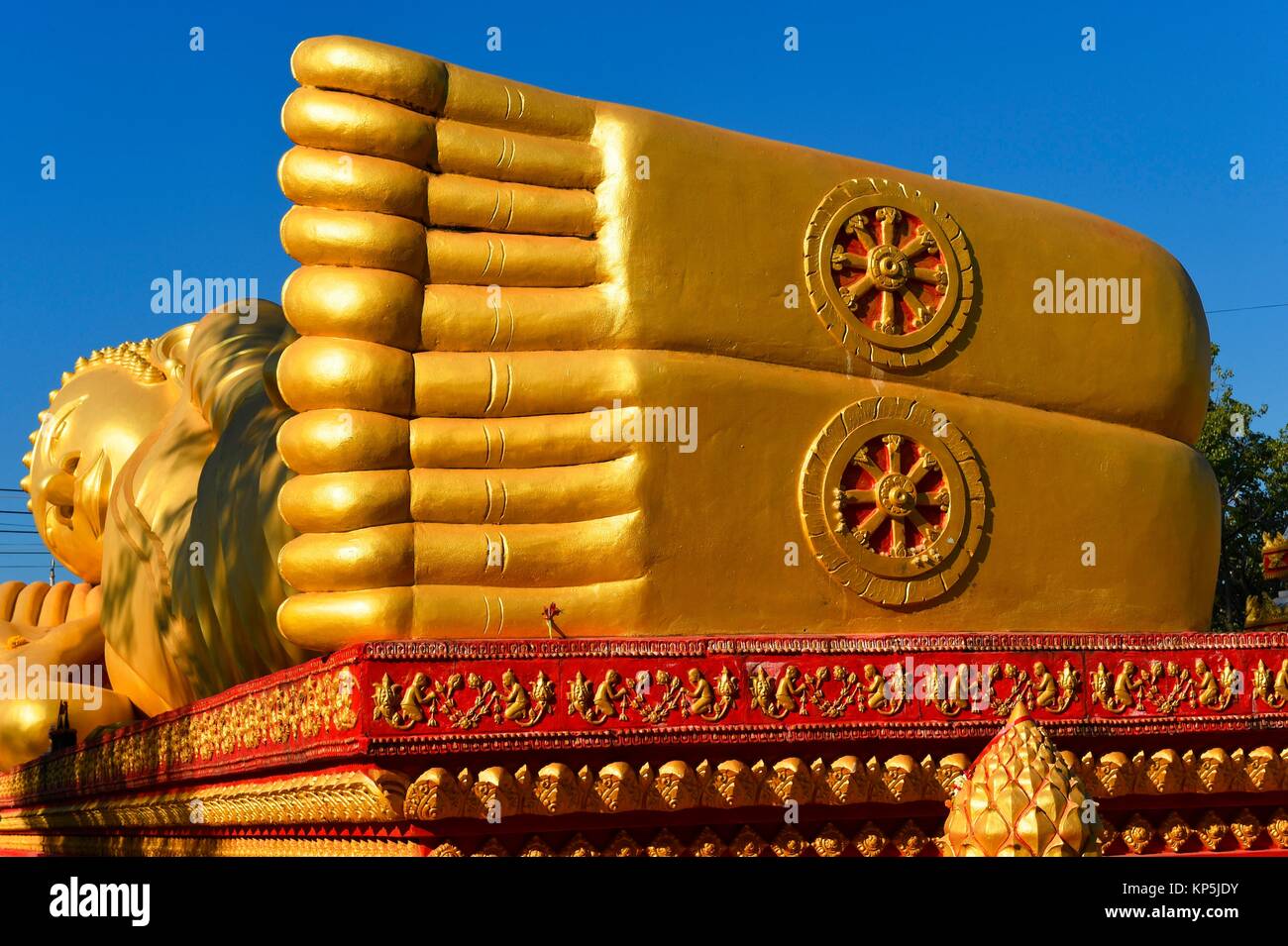 Giant gold reclining sleeping Buddha statue near Wat That Luang temple,Vientiane,Laos,Southeast Asia. Stock Photo