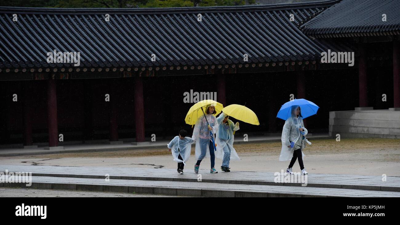 People under umbrella visit Changdeokgung Palace,Seoul,South Korea. Stock Photo