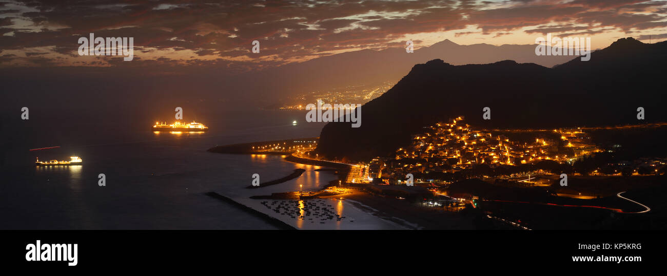 Beautiful sunset panorama background in Tenerife, Canary Islands with the silhouette of Teide volcano; Las Teresitas beach with San Andrés, photographed from Mirador Las Teresitas by night Stock Photo