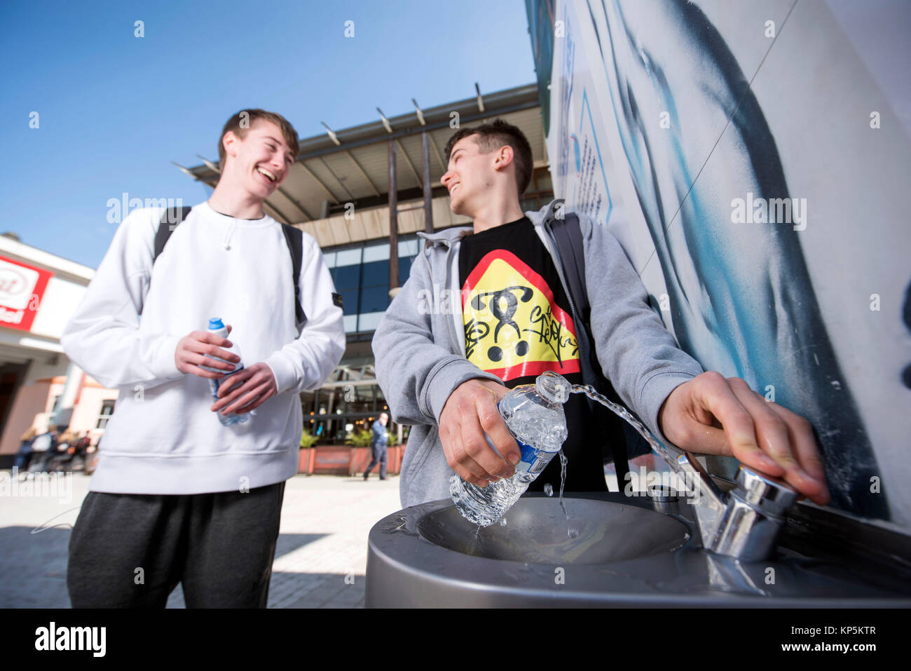 ‘City To Sea’, a campaign to rid Bristol of plastic bottle waste - students refilling their water bottles in Millennium Square Stock Photo