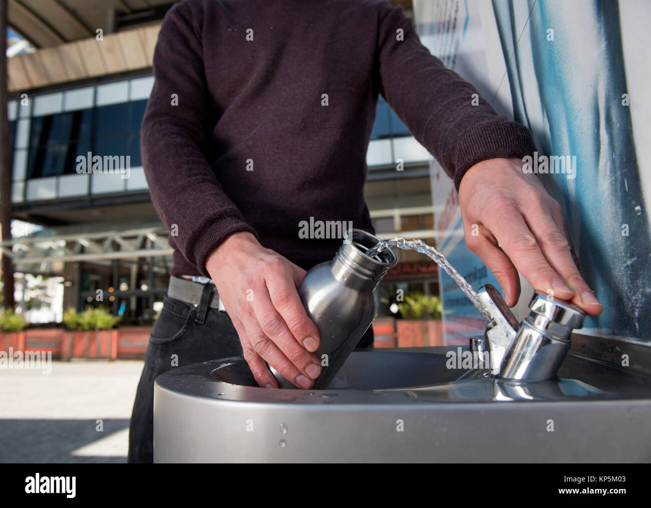 ‘City To Sea’, a campaign to rid Bristol of plastic bottle waste - a student refills his water bottle in Millennium Square Stock Photo