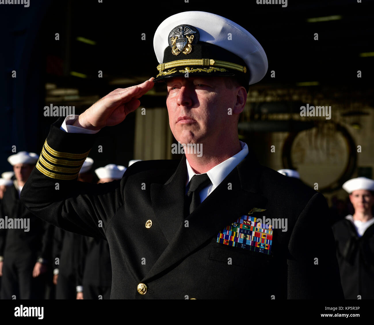 U.S. Navy Commanding Officer Kevin Lenox renders a salute during a burial at sea aboard the U.S. Navy Nimitz-class aircraft carrier USS Nimitz December 6, 2017 in the Pacific Ocean.  (photo by Emily Johnston via Planetpix) Stock Photo