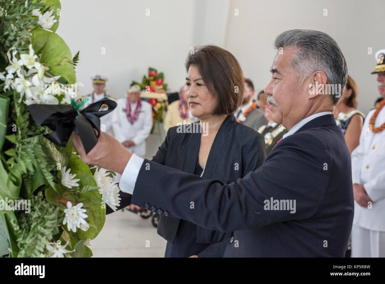 U.S. Hawaii Governor David Ige pays his respects to fallen service members at a floral tribute aboard the USS Arizona Memorial during the 76th Commemoration of the attacks on Pearl Harbor and Oahu at the December 7, 2017 in Honolulu, Hawaii.  (photo by Katarzyna Kobiljak via Planetpix) Stock Photo
