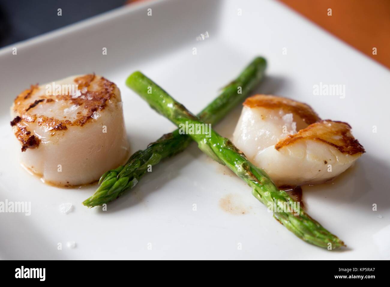 Roasted scallops with green asparagus on plate Stock Photo Alamy