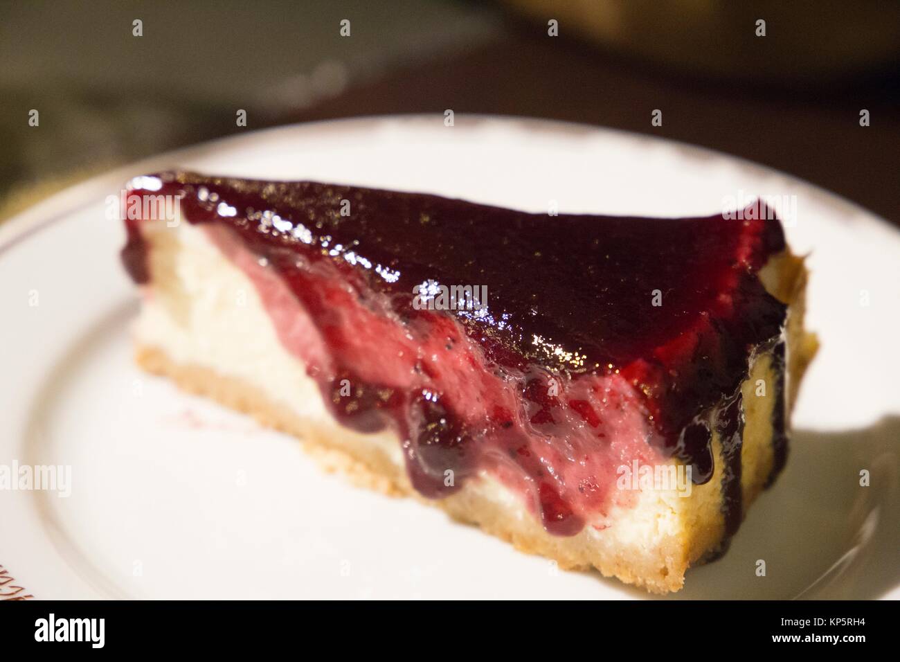 Piece of cheesecake topped with cherry compote Stock Photo Alamy