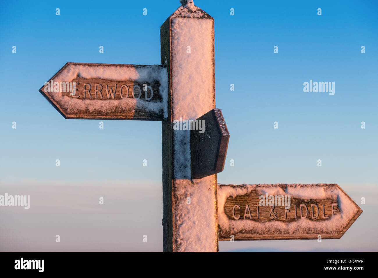 Snow covered finger post / footpath sign for Errwood and The Cat And Fiddle in The Peak District National Park Stock Photo