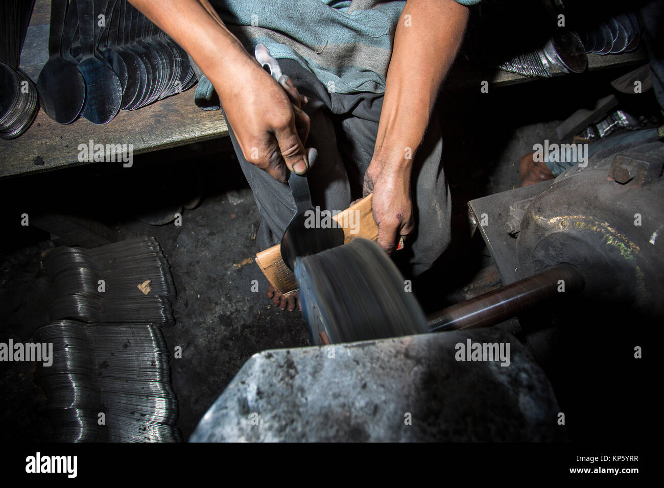 Spoon-Making Factory Workers at a steel recycling and steel spoon ...