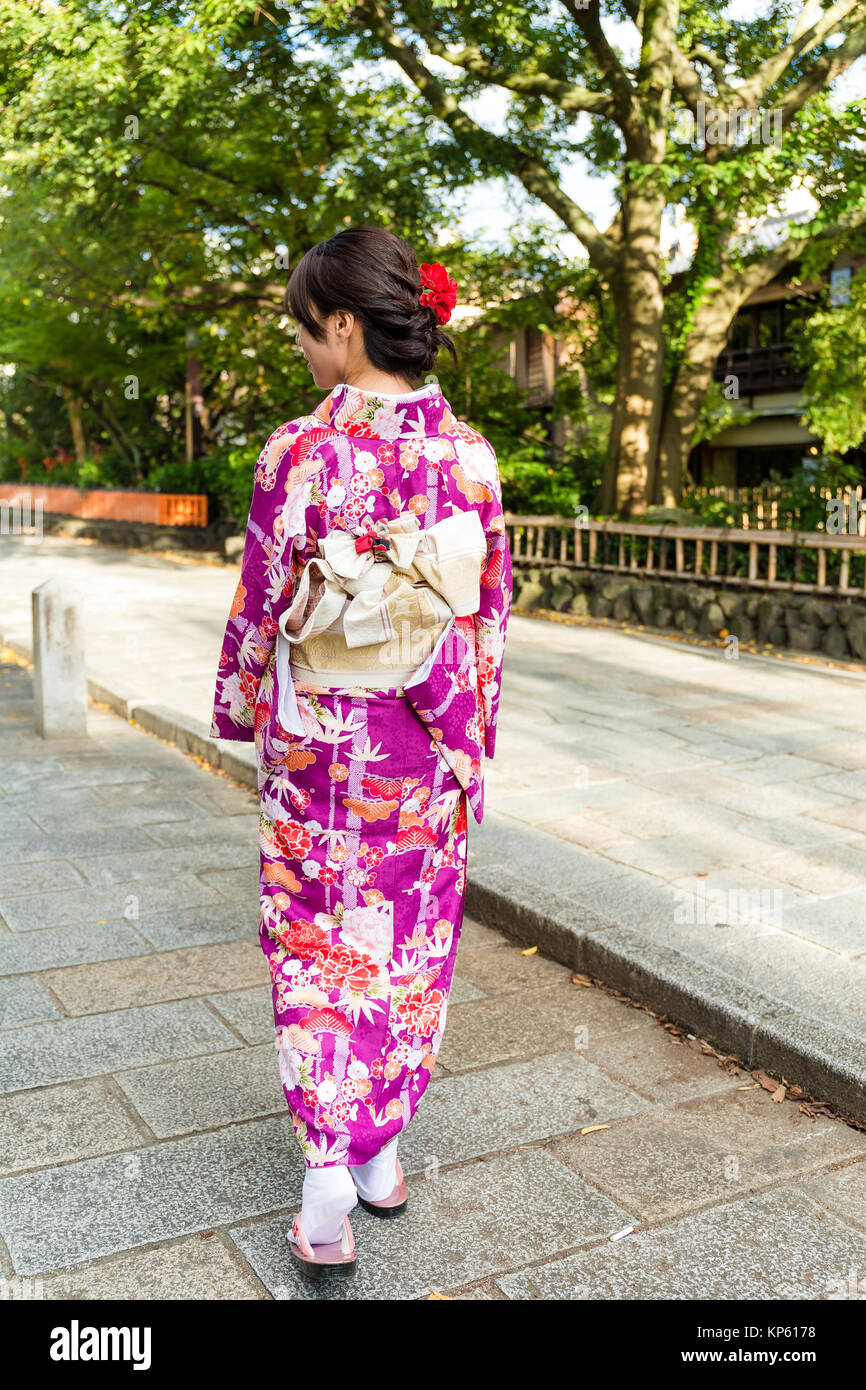 Solo woman in elegant kimono walking through Gion street showcasing the poise and grace that kimono naturally brings