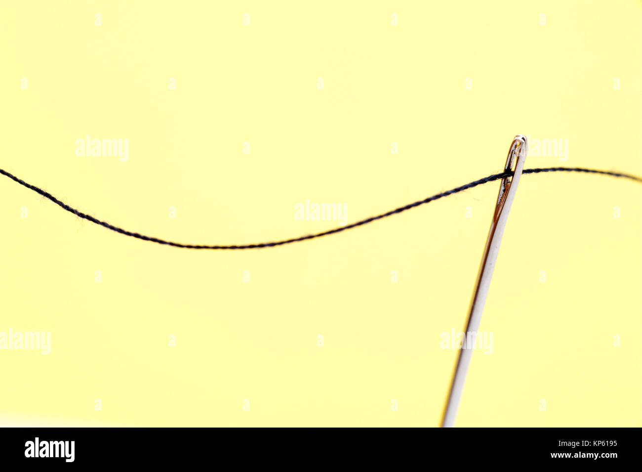 Threaded sewing needle Stock Photo Alamy