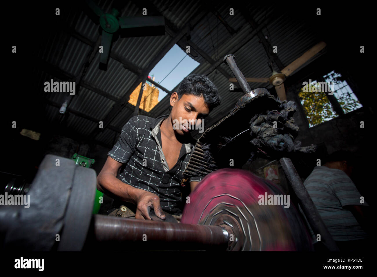 Ashiq Age 20 is working at a small factory near of Burigonga River at ...