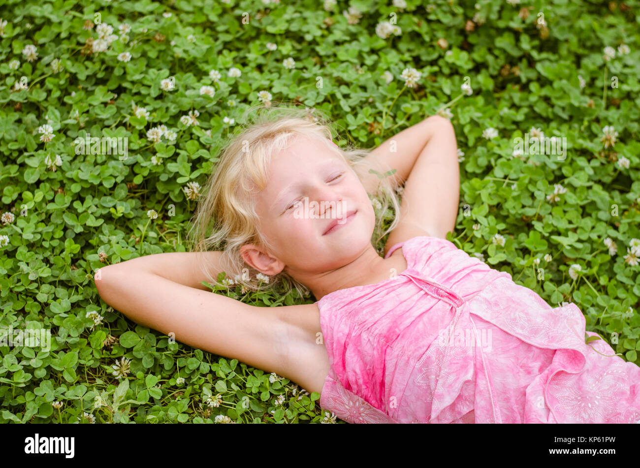 little lovely girl lying on the grass and enjoying life Stock Photo - Alamy