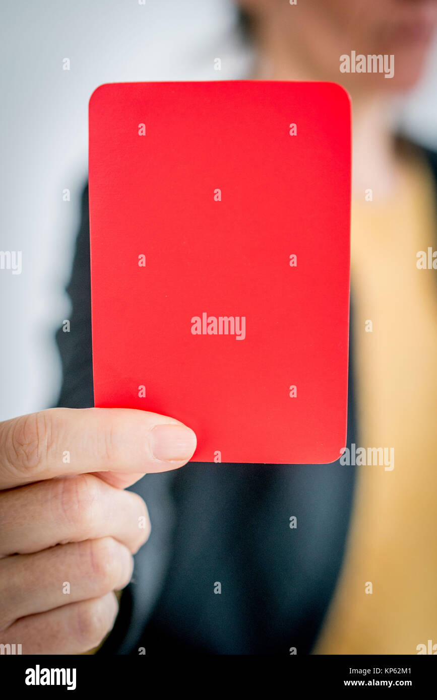 Woman holding up red penalty card Stock Photo Alamy