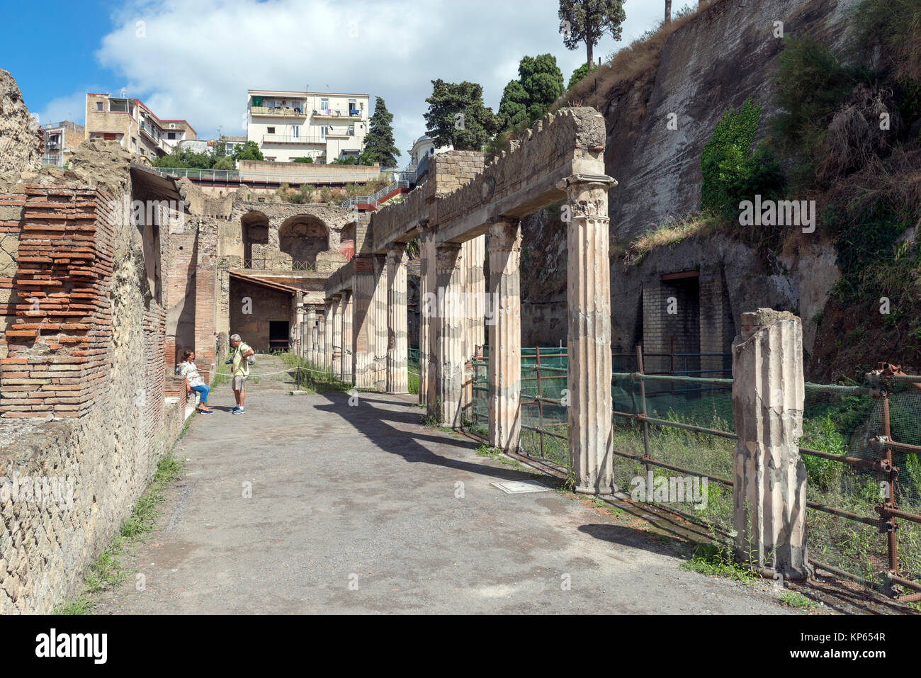 Tourists on a street in the Roman ruins at Herculaneum (Ercolano), Naples, Campania, Italy Stock Photo