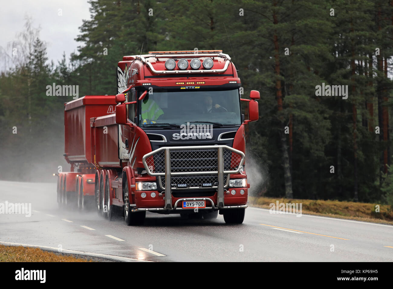 SALO, FINLAND - DECEMBER 8, 2017: Red Scania R730 double trailer truck of R Aalto hauls limestone on wet road in South of Finland. Stock Photo