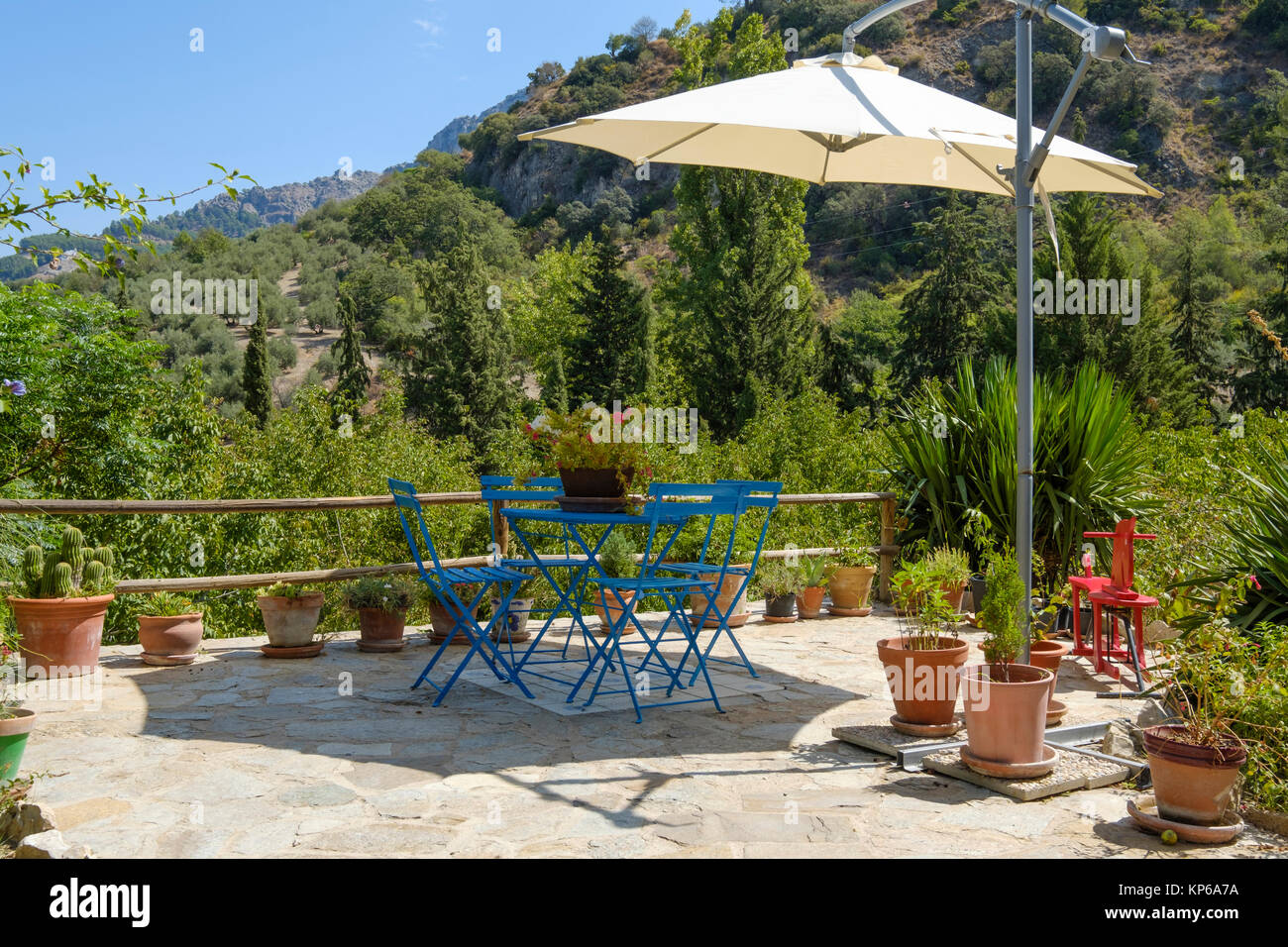 large parasol above a garden set in a beautiful setting with lots of decoration Stock Photo