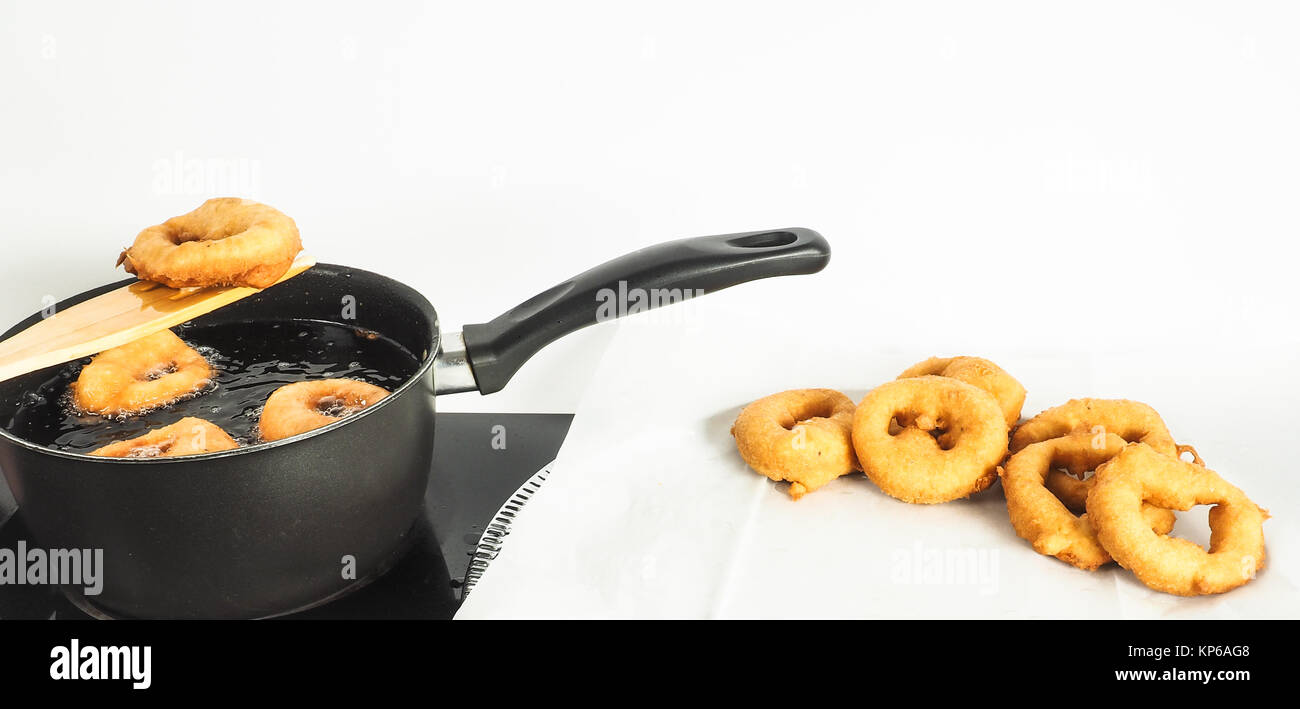 Fresh made doughnuts from boiling hot oil Stock Photo Alamy