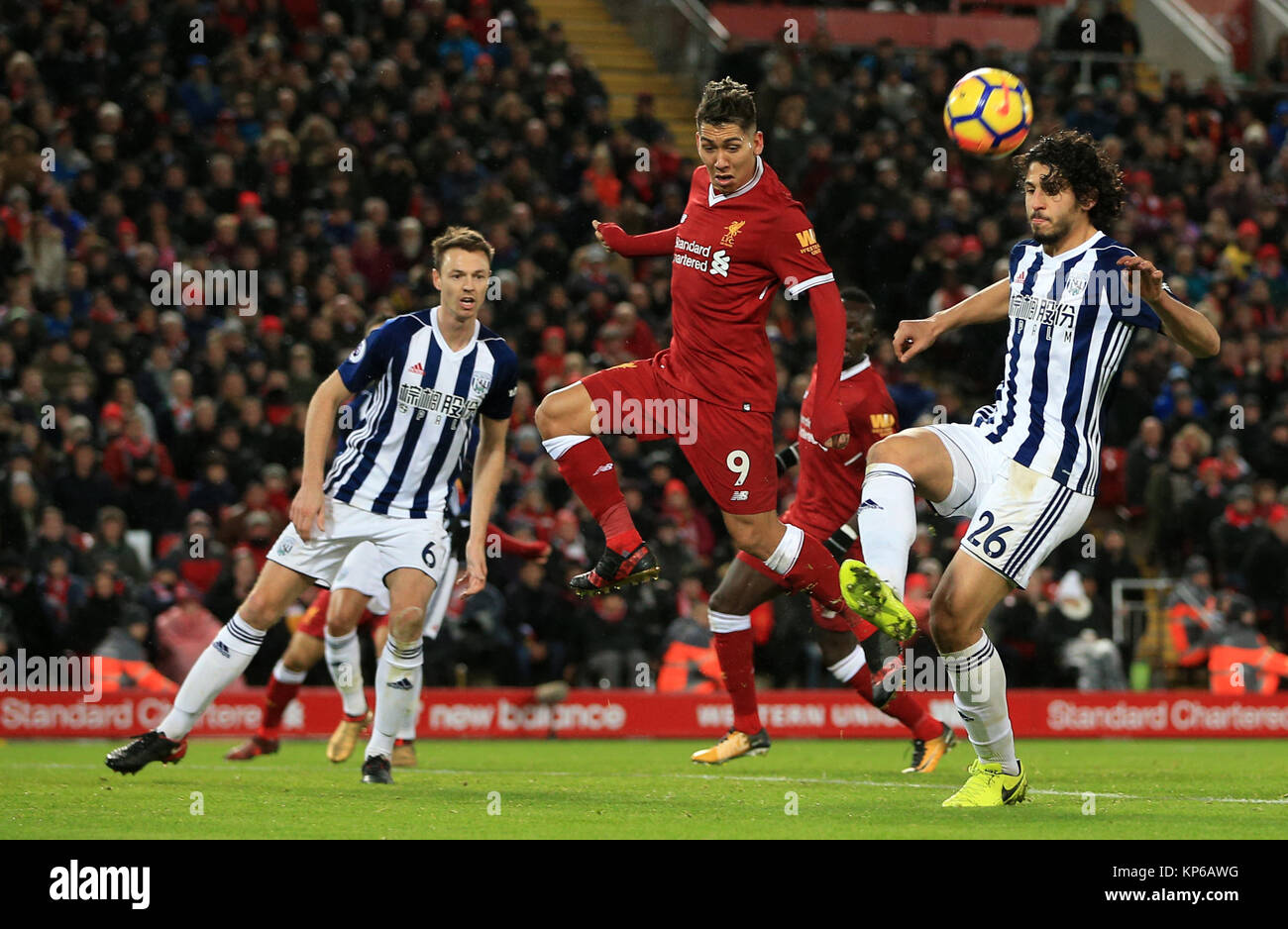 Liverpool's Roberto Firmino and West Bromwich Albion's Ahmed Hegazy battle for the ball during the Premier League match at Anfield, Liverpool. Stock Photo