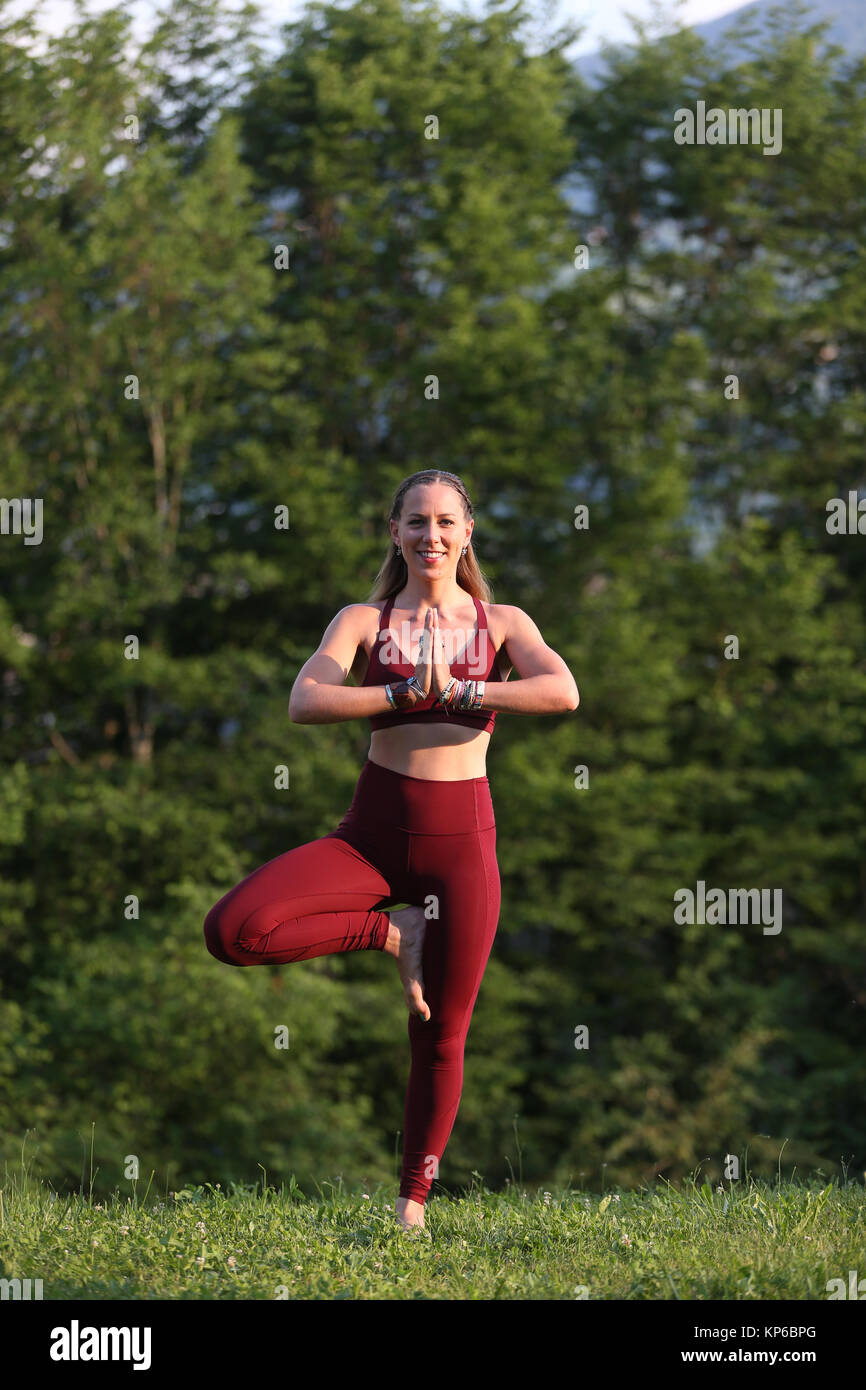 Woman doing yoga and meditation outside. Saint-Gervais. France. Stock Photo