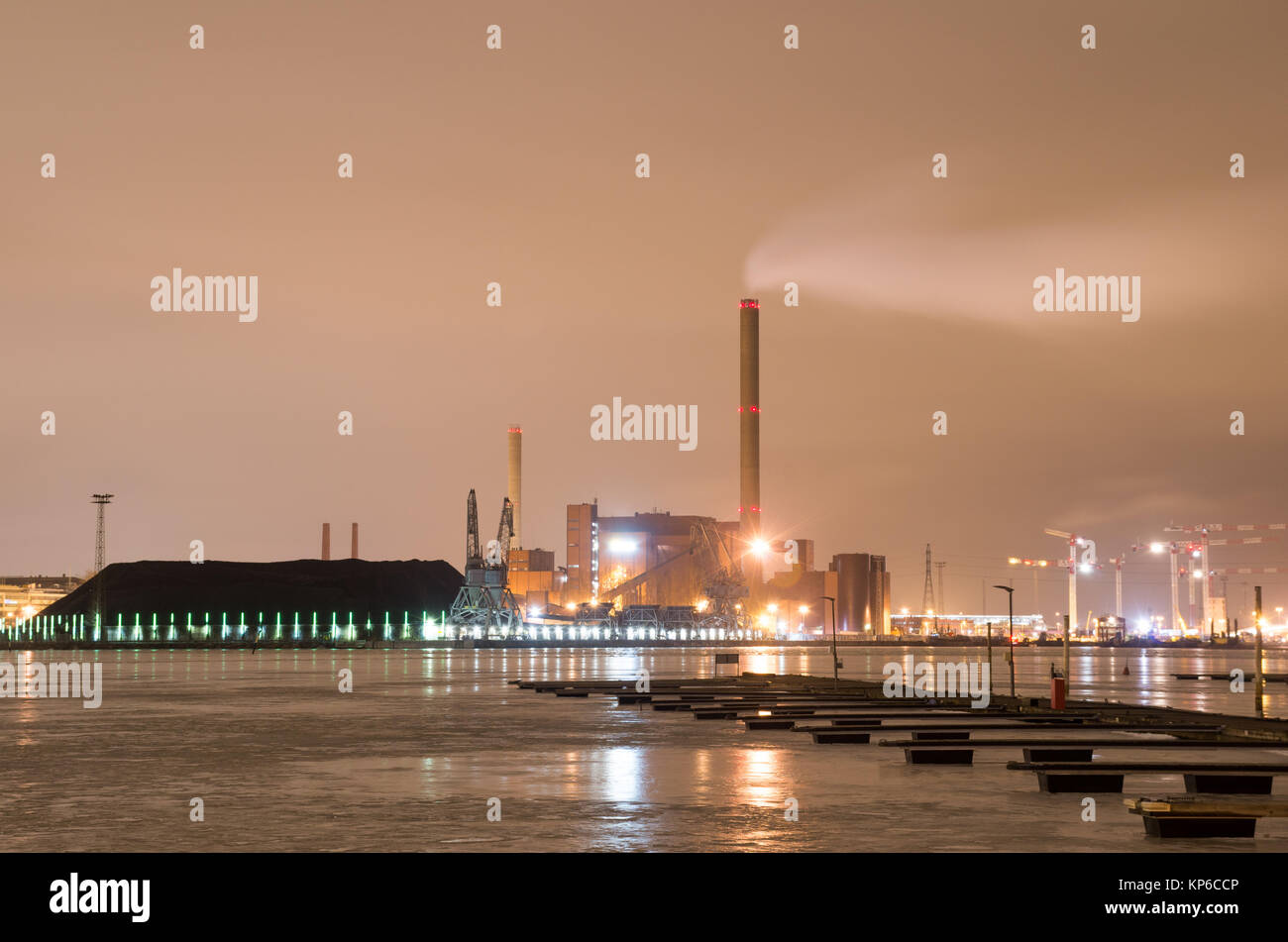 A long exposure night scene of the coal power plant in Helsinki as seen from opposite shore. Stock Photo