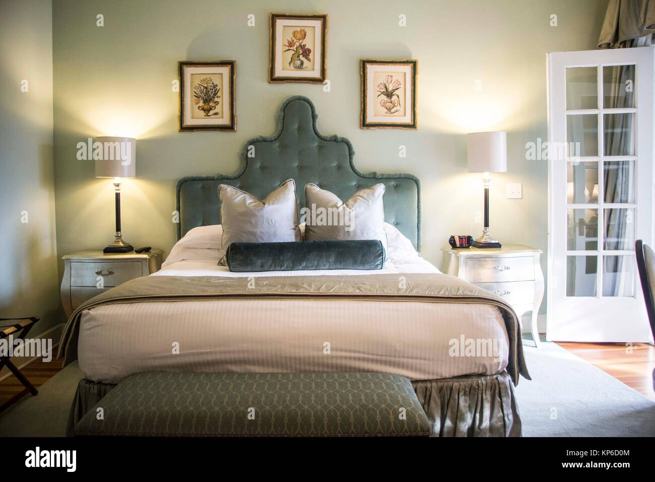 Beautiful old fashion soft green headboard bed with double french doors