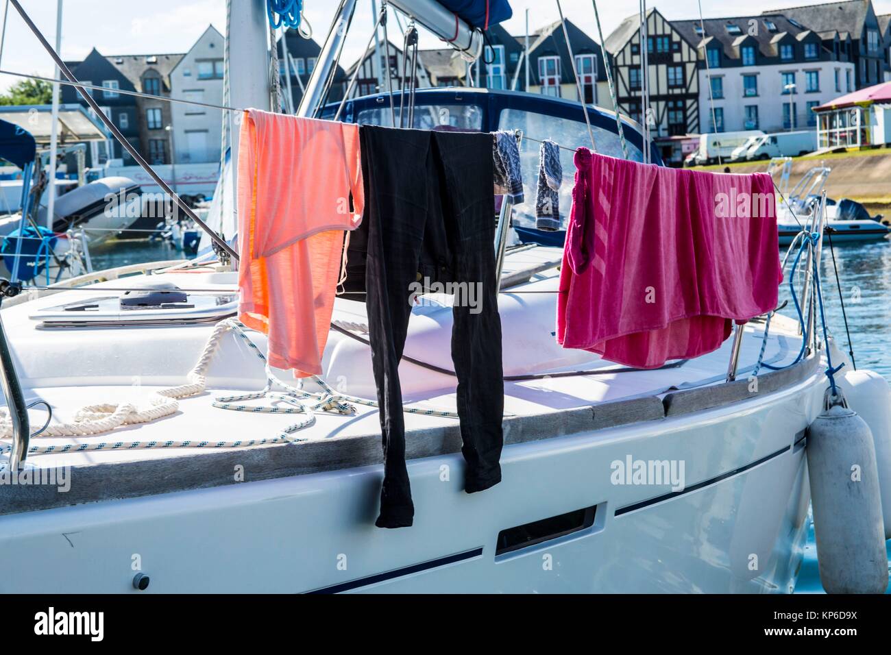 Laundry hanged on the sail of the sailboat to dry as there are no