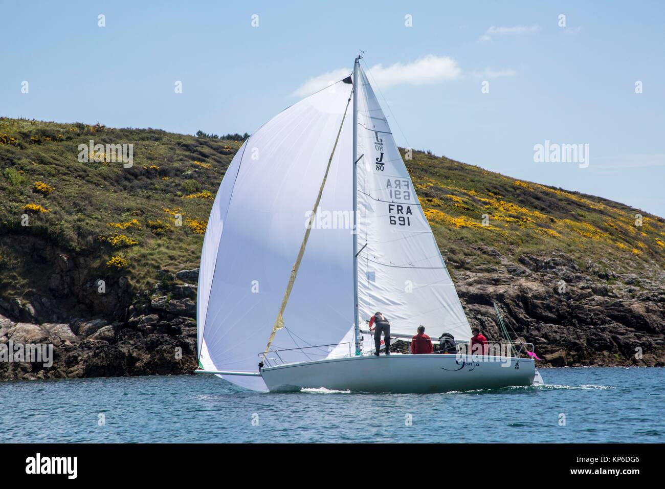 Sail boat with full sail and full wind passing by in the French ocean