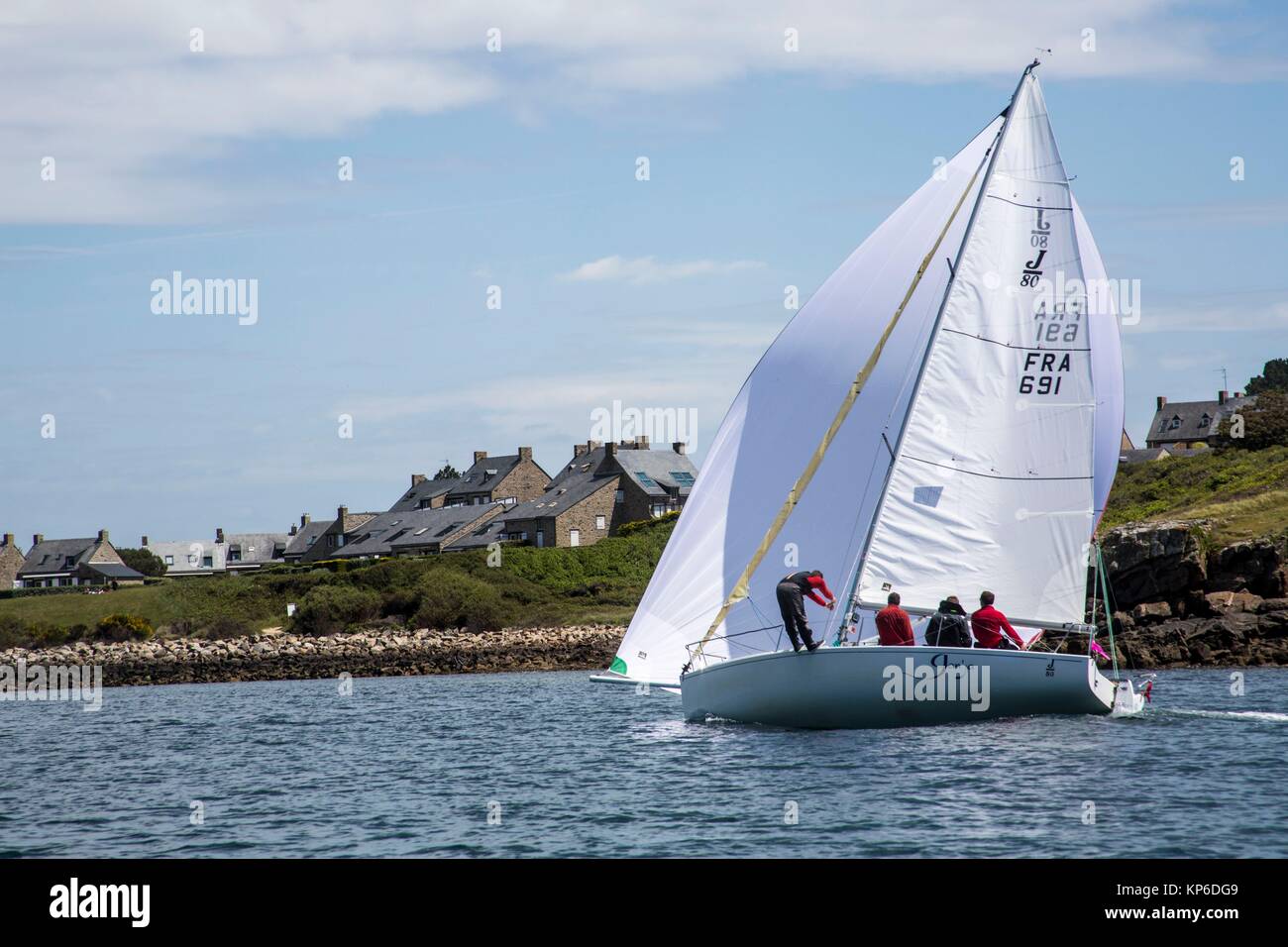 Sail boat with full sail and full wind passing by in the French ocean