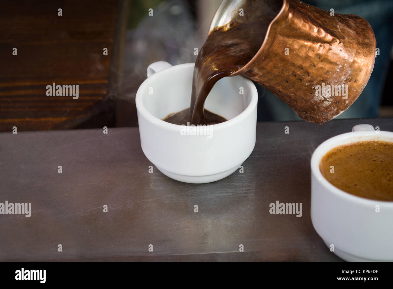 preparing coffee in pots on hot coals Stock Photo Alamy