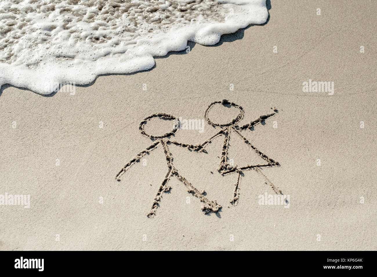 Paar im Sandstrand - couple at the beach, symbolic for Stock Photo