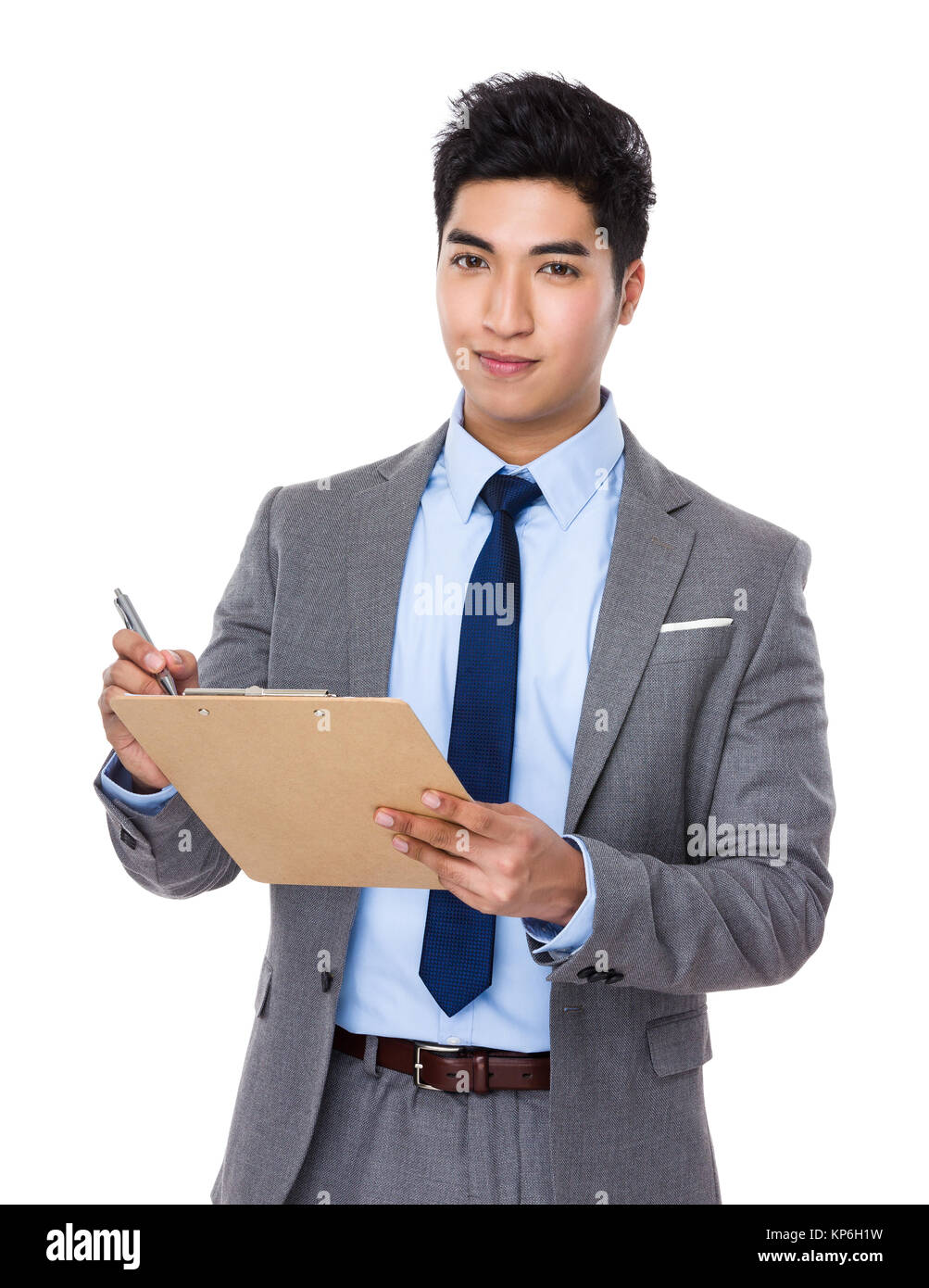 Asian young businessman take note on clipboard Stock Photo - Alamy