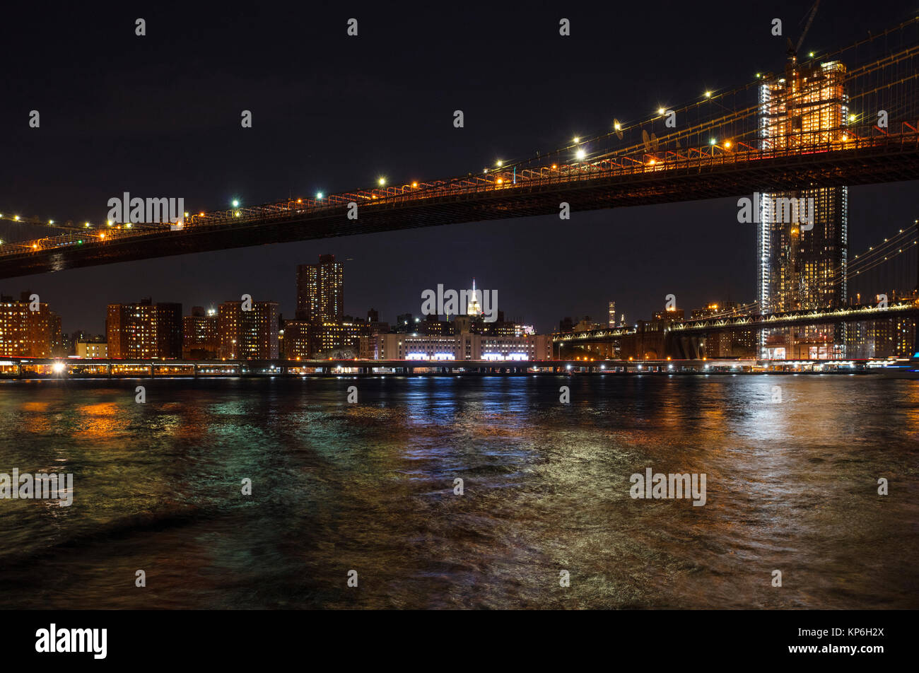 New York, Manhattan Skyline and Brooklyn Bridge at Night reflected in ...
