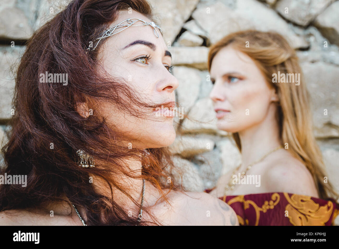 two women faces that stand back to wall Stock Photo