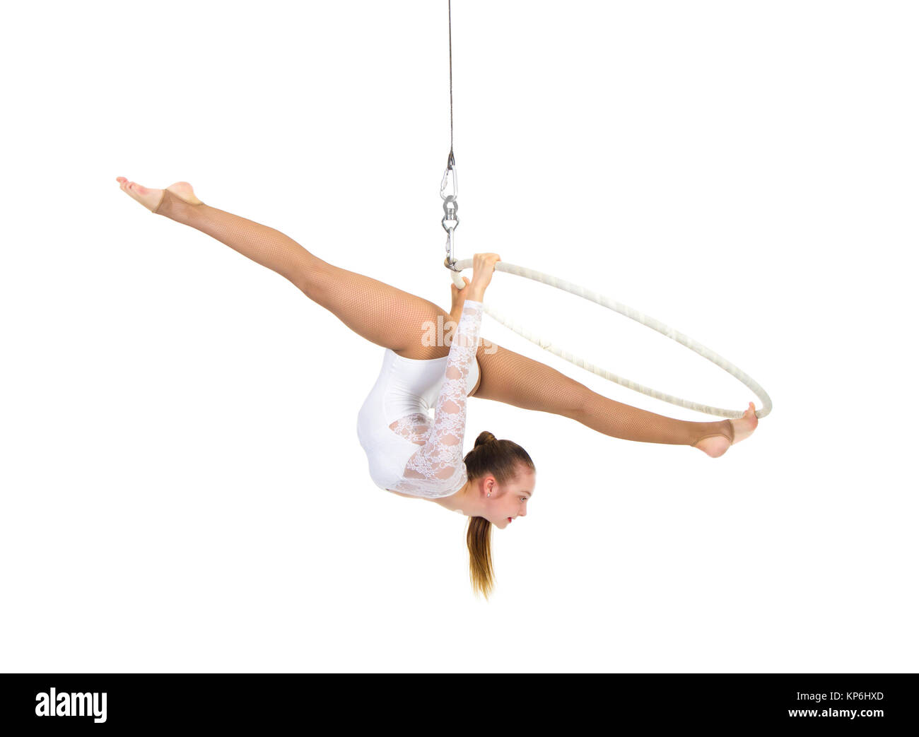A young woman performs the acrobatic elements in the air ring. Studio ...