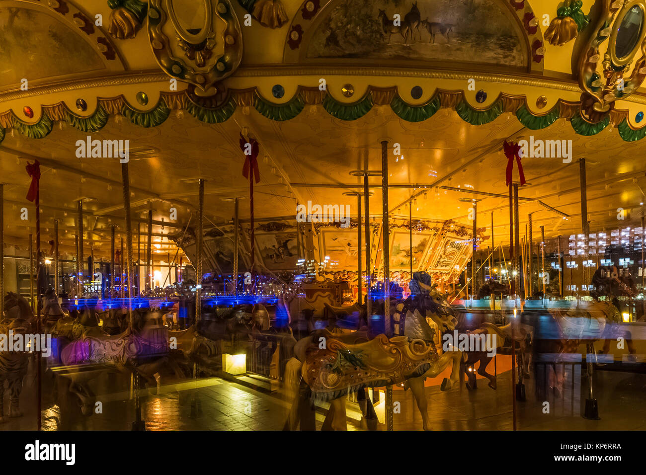 1928 Spillman Carousel in the Grand Rapids Public Museum viewed from outside at night near the Grand River in Grand Rapids, Michigan, USA Stock Photo