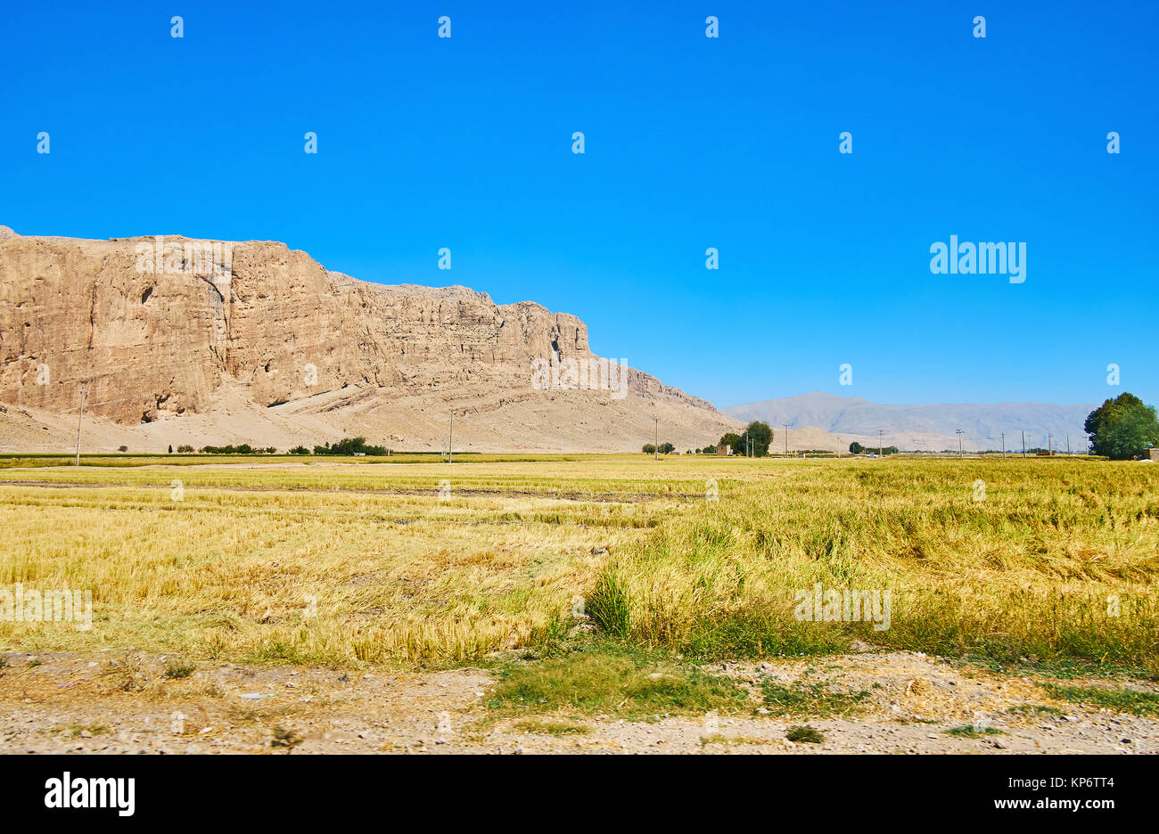 The dry agricultural lands of Fars Province with a view on Rahmet Mount of Zagros mountain range, Persepolis, Iran. Stock Photo
